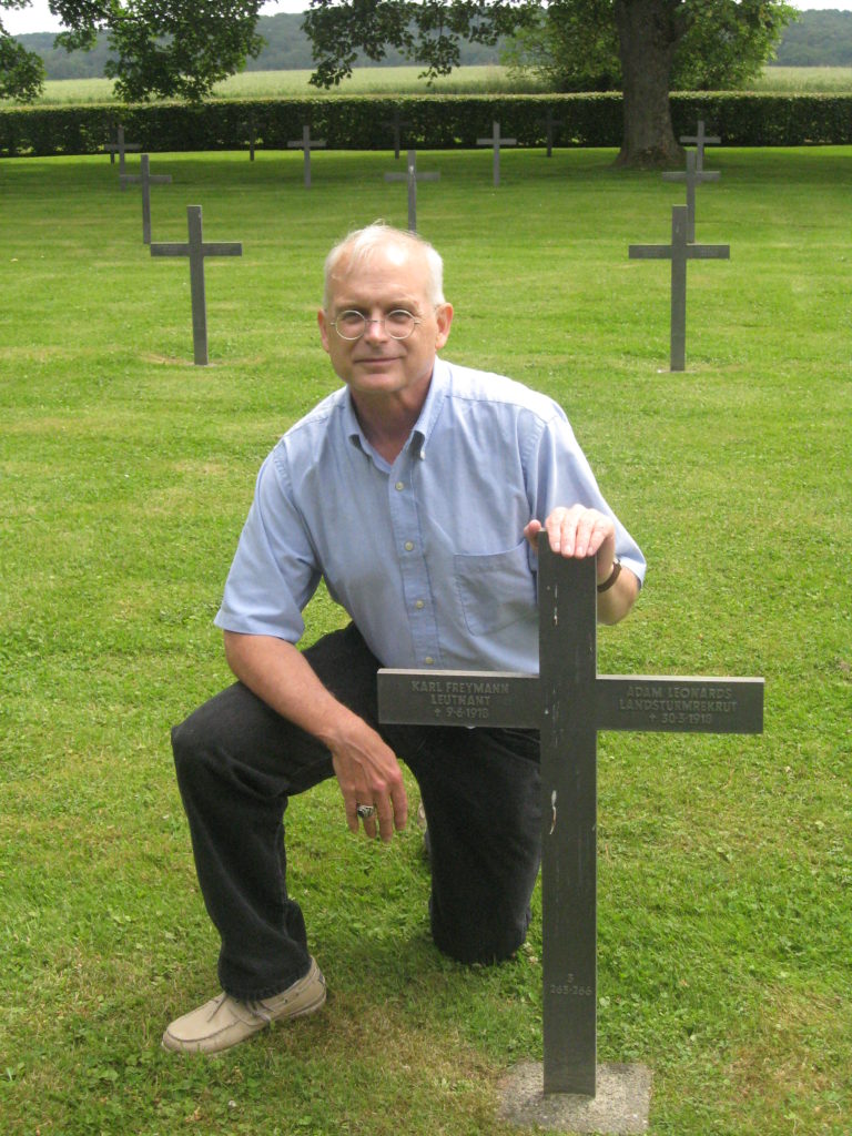The author's friend and client kneeling next to his great uncle's grave in the German Military Cemetery in Lassigny, France.
