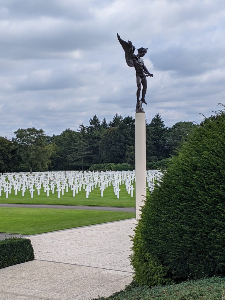O this 28th Infantry Division Battlefield Tour we will visit the Henri-Chapelle American Cemetery. The bronze statue of the Angle of Peace is bestowing the olive branch upon the heroic dead at Henri-Chapelle American Cemetery in Belgium