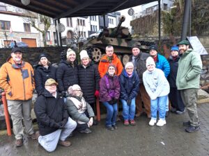 Explore the Ardennes "Battle of the Bulge" on our December tour. Here, 2024 tour participants stand in front of the German Panther Tank at Houffalize, Belgium.