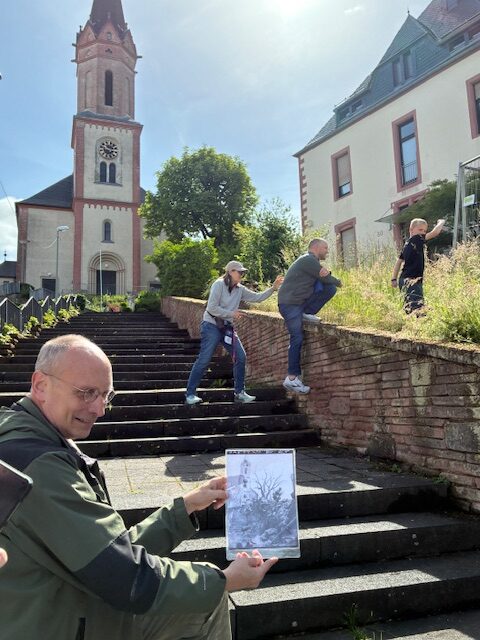 Matching up a then and now photo by the St. Peter's Church, Bous, Germany on the 65th Infantry Division Association's Right to be Proud Tour.