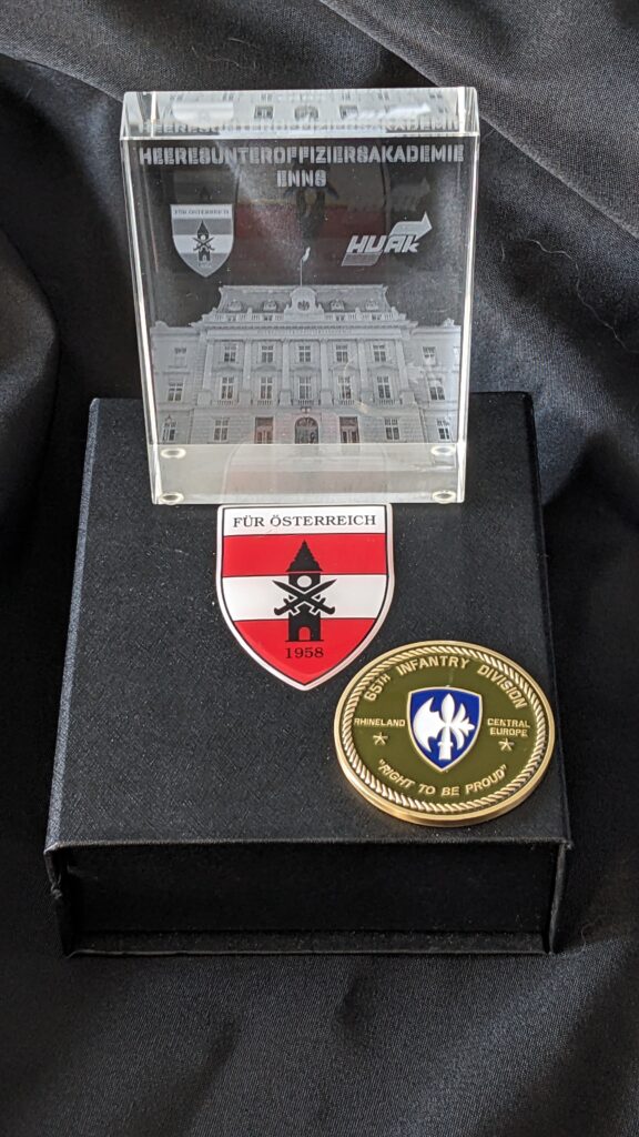 Commemorative plaque from Austria's NCO Academy in Linz, Austria and 65th Infantry Division challenge Coin are positive battlefield tour feedback!